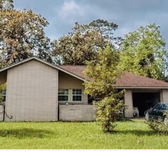 view of front of home featuring a front yard and an attached garage
