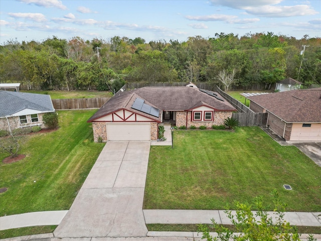 314 Lantana Dr, Texas City, TX 77591 - view of front of house featuring fence, roof mounted solar panels, a garage, a front lawn, and driveway