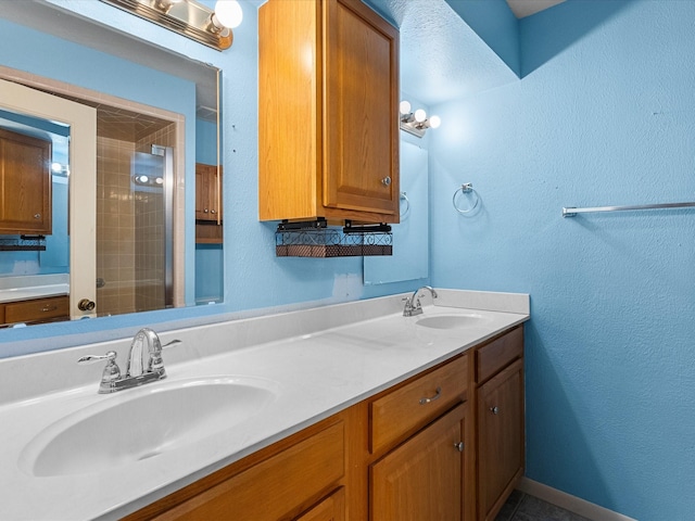 314 Lantana Dr, Texas City, TX 77591 - full bath with double vanity, a sink, baseboards, and an enclosed shower