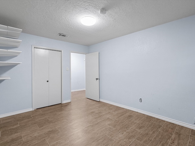 314 Lantana Dr, Texas City, TX 77591 - unfurnished bedroom featuring baseboards, visible vents, a closet, and wood finished floors
