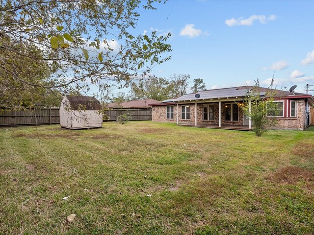 314 Lantana Dr, Texas City, TX 77591 - view of yard featuring an outbuilding, a fenced backyard, and a storage shed