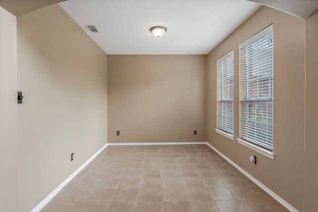 unfurnished room featuring visible vents, baseboards, and light tile patterned flooring