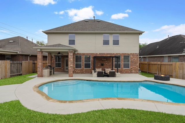 view of swimming pool featuring ceiling fan, a patio area, a fenced in pool, a fenced backyard, and an outdoor living space with a fire pit