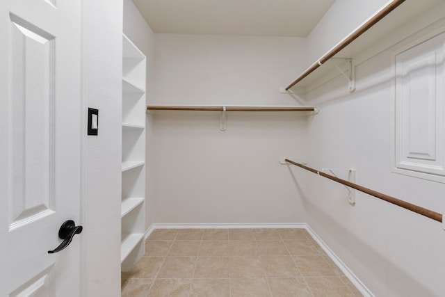 spacious closet featuring light tile patterned flooring