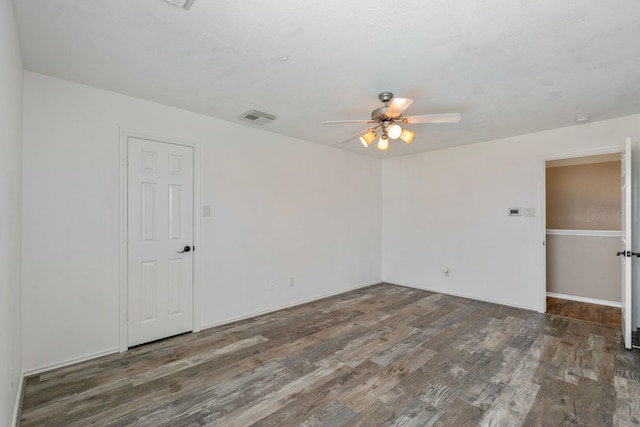 unfurnished room featuring ceiling fan, visible vents, and wood finished floors