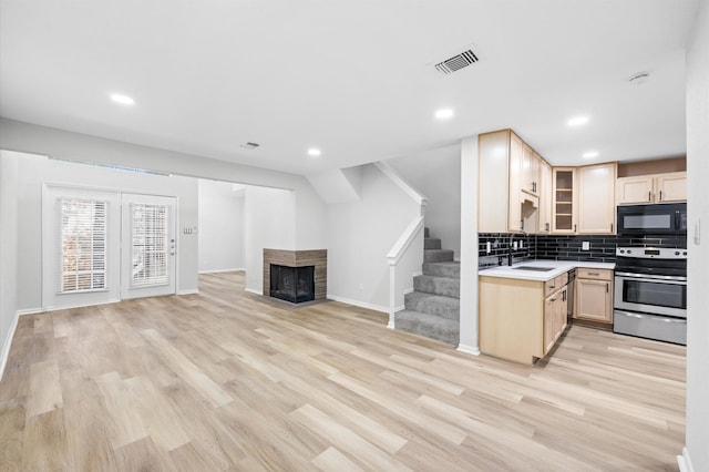 16800 Sugar Pine Dr Unit F51, Houston, TX 77090 - kitchen featuring stainless steel range with electric cooktop, black microwave, visible vents, a sink, and light brown cabinets