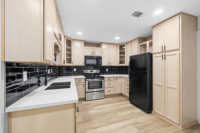 16800 Sugar Pine Dr Unit F51, Houston, TX 77090 - kitchen featuring light brown cabinets, black appliances, visible vents, light wood finished floors, and a sink