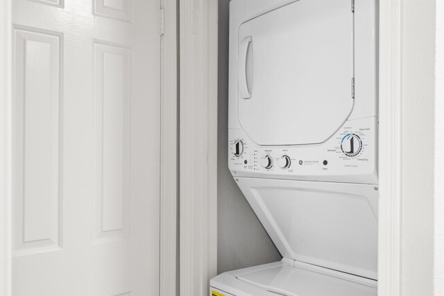 16800 Sugar Pine Dr Unit F51, Houston, TX 77090 - clothes washing area with stacked washing maching and dryer and laundry area