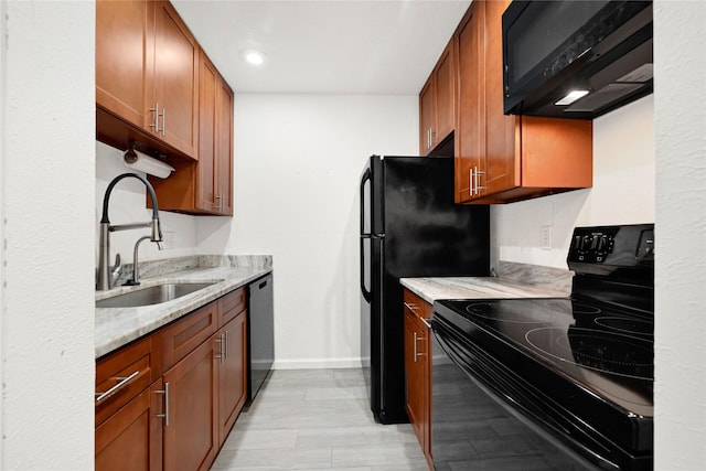 5001 Lamonte Ln Unit 110, Houston, TX 77092 - kitchen with light stone counters, a sink, black appliances, baseboards, and recessed lighting