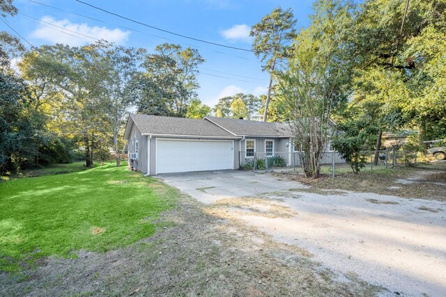 ranch-style house featuring stucco siding, fence, driveway, a front yard, and a garage