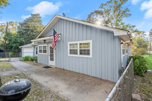 view of front of home with a gate, fence, and board and batten siding