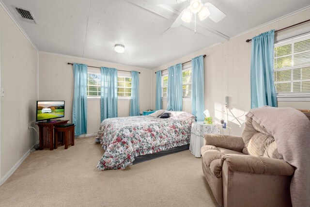 carpeted bedroom featuring ornamental molding, ceiling fan, and visible vents