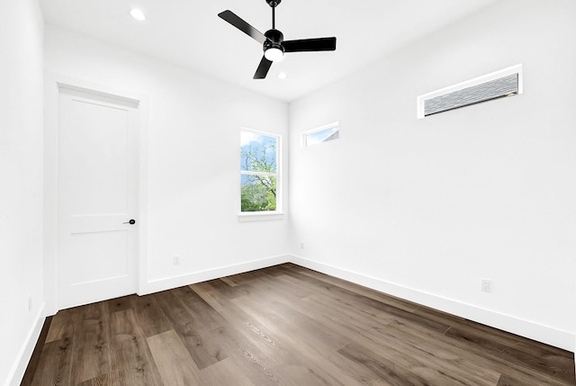 empty room with recessed lighting, dark wood-style flooring, baseboards, ceiling fan, and visible vents