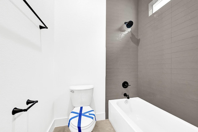 full bathroom featuring baseboards, toilet, and shower / bath combination