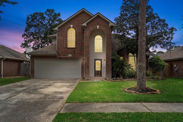traditional home featuring brick siding, driveway, and a front yard
