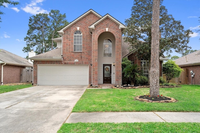 traditional-style home featuring concrete driveway, a front lawn, brick siding, and fence