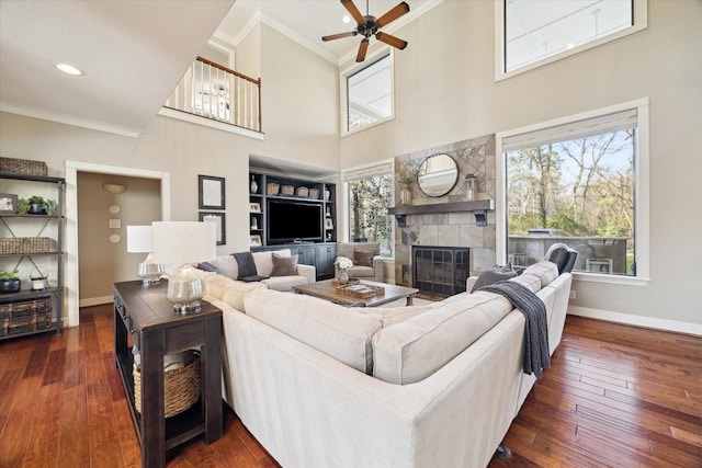 271 W Pines Dr, Montgomery, TX 77356 - living room with ornamental molding, a fireplace, a ceiling fan, baseboards, and dark wood finished floors