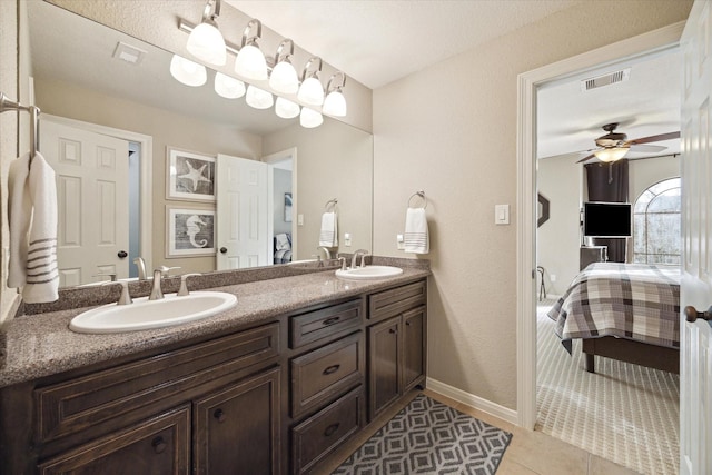 271 W Pines Dr, Montgomery, TX 77356 - full bath with ensuite bath, double vanity, ceiling fan, tile patterned flooring, and baseboards