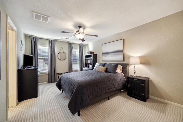 271 W Pines Dr, Montgomery, TX 77356 - bedroom featuring light carpet, baseboards, ceiling fan, a textured wall, and a textured ceiling