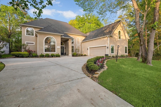 271 W Pines Dr, Montgomery, TX 77356 - view of front of house with concrete driveway, a front lawn, stucco siding, and a garage
