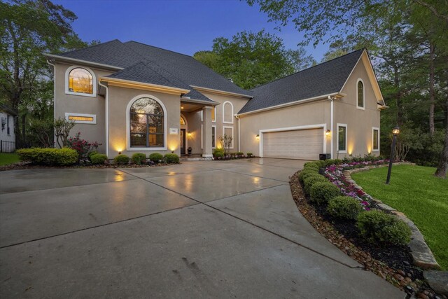 271 W Pines Dr, Montgomery, TX 77356 - view of front of property with driveway, stucco siding, roof with shingles, a garage, and a front yard