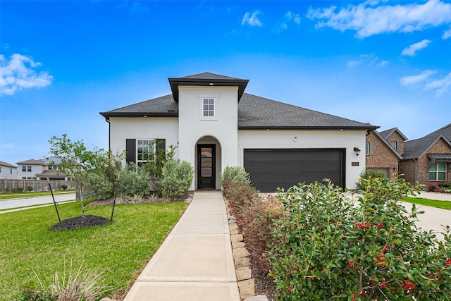 9603 Crescent Mill Dr, Missouri City, TX 77459 - view of front of home with an attached garage, a shingled roof, stucco siding, and a front lawn