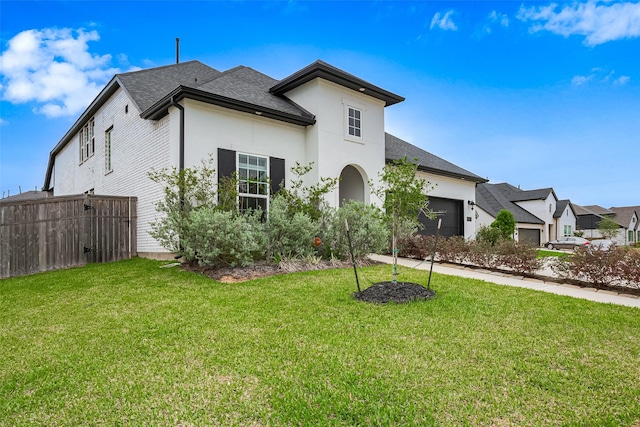 9603 Crescent Mill Dr, Missouri City, TX 77459 - view of front of house featuring roof with shingles, a garage, a front yard, and stucco siding