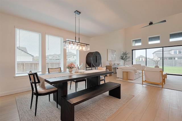 9603 Crescent Mill Dr, Missouri City, TX 77459 - dining area with light wood finished floors, a notable chandelier, and baseboards