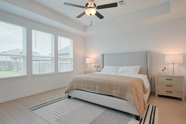 9603 Crescent Mill Dr, Missouri City, TX 77459 - bedroom with visible vents, light wood-type flooring, and multiple windows