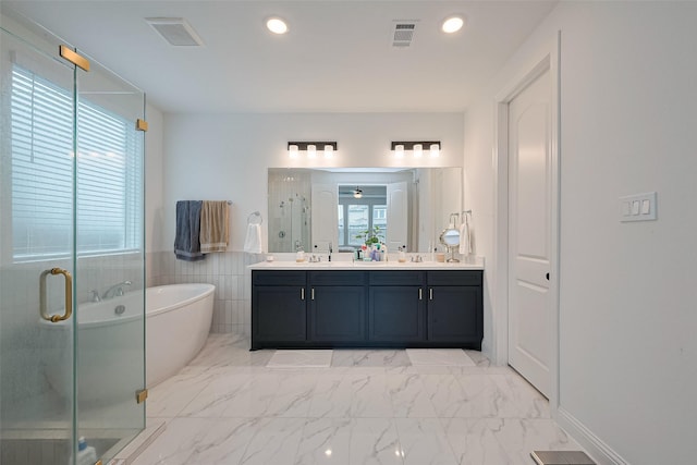 9603 Crescent Mill Dr, Missouri City, TX 77459 - bathroom with double vanity, a stall shower, visible vents, a freestanding bath, and marble finish floor