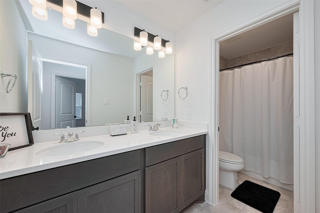 9603 Crescent Mill Dr, Missouri City, TX 77459 - bathroom featuring tile patterned floors, double vanity, a sink, and toilet