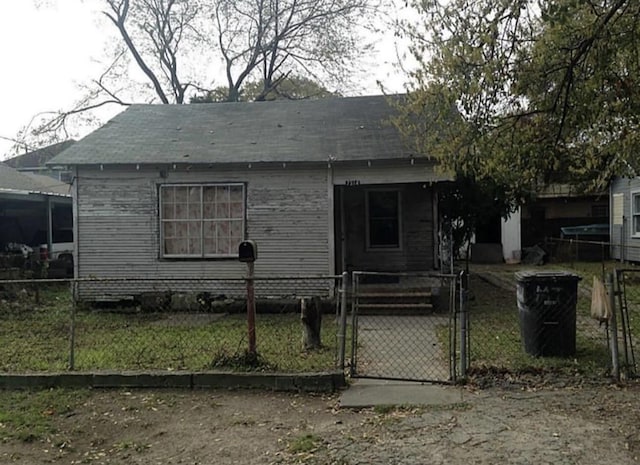 exterior space with a gate and a fenced front yard