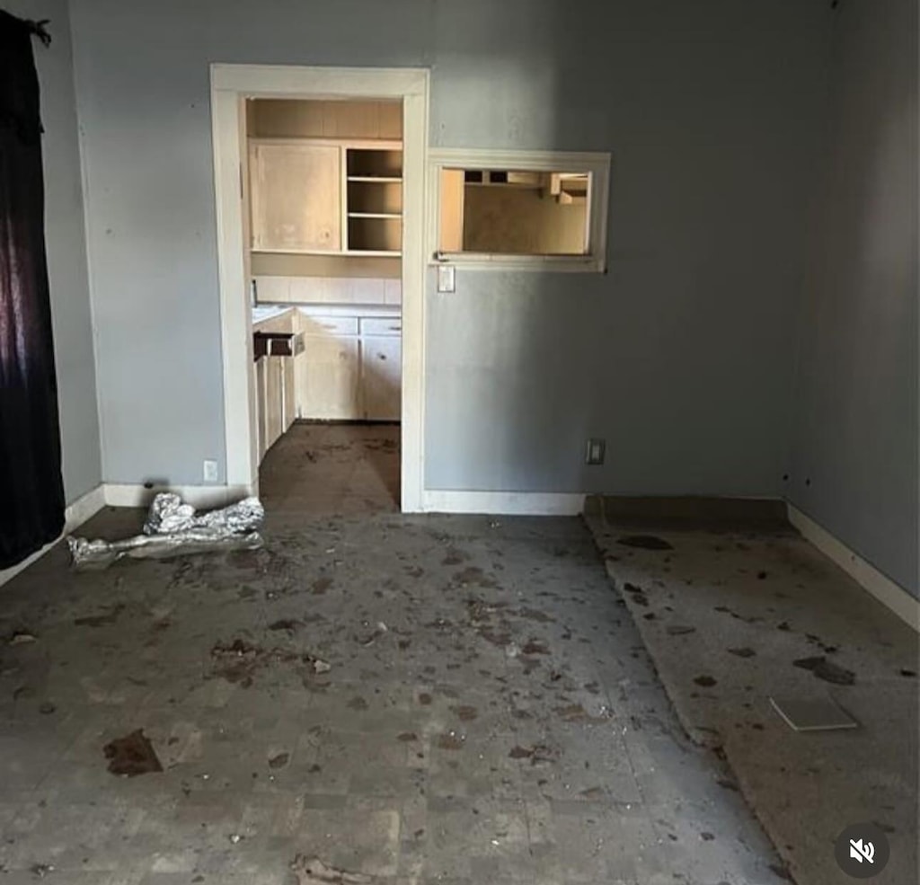 spare room featuring baseboards