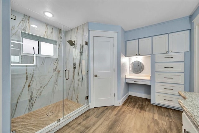 126 Tamana Dr, Tiki Island, TX 77554 - bathroom with baseboards, wood finished floors, vanity, and a marble finish shower