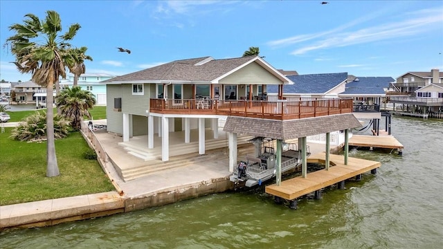126 Tamana Dr, Tiki Island, TX 77554 - view of dock featuring a water view, a patio, boat lift, a residential view, and a lawn