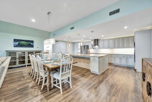 126 Tamana Dr, Tiki Island, TX 77554 - dining room featuring light wood-type flooring, recessed lighting, and visible vents
