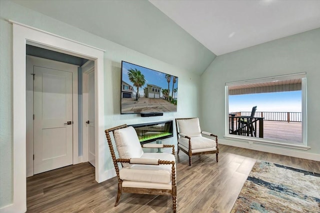 126 Tamana Dr, Tiki Island, TX 77554 - sitting room featuring baseboards, vaulted ceiling, and wood finished floors
