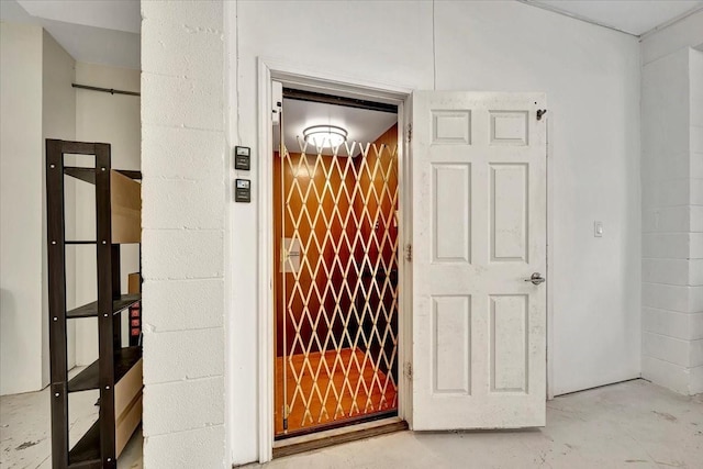 126 Tamana Dr, Tiki Island, TX 77554 - interior details featuring elevator and unfinished concrete flooring
