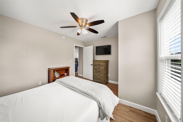 2008 71st St, Galveston, TX 77551 - bedroom featuring baseboards, wood finished floors, and a ceiling fan