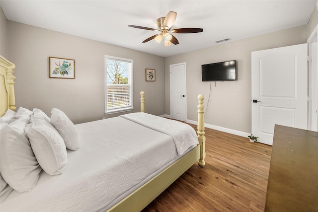 2008 71st St, Galveston, TX 77551 - bedroom with wood finished floors, baseboards, and ceiling fan