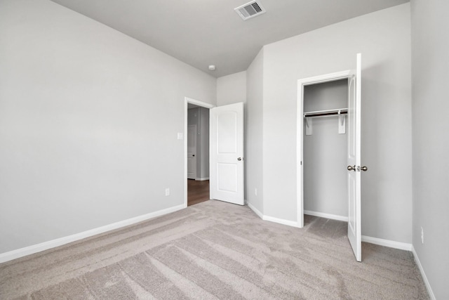 unfurnished bedroom with carpet, baseboards, and visible vents