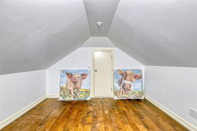 49 Regency Pt, Conroe, TX 77356 - bonus room with baseboards, vaulted ceiling, a textured ceiling, and wood-type flooring