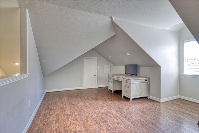 49 Regency Pt, Conroe, TX 77356 - unfurnished office featuring baseboards, wood finished floors, and vaulted ceiling