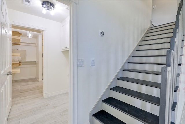 49 Regency Pt, Conroe, TX 77356 - staircase featuring baseboards, visible vents, and wood finished floors