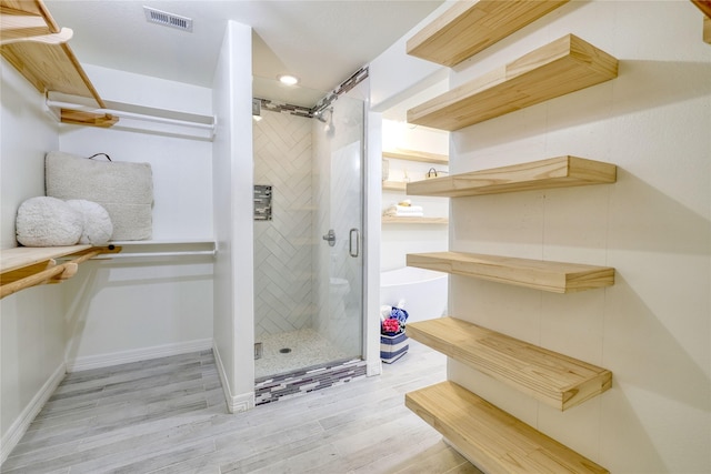 49 Regency Pt, Conroe, TX 77356 - full bath with a stall shower, wood finished floors, baseboards, visible vents, and recessed lighting