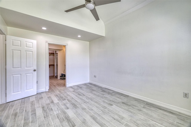 49 Regency Pt, Conroe, TX 77356 - unfurnished bedroom featuring a spacious closet, baseboards, light wood finished floors, and recessed lighting