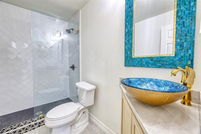 49 Regency Pt, Conroe, TX 77356 - full bath with vanity, baseboards, toilet, and tiled shower