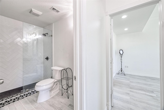 49 Regency Pt, Conroe, TX 77356 - bathroom with a shower stall, visible vents, wood finished floors, and toilet