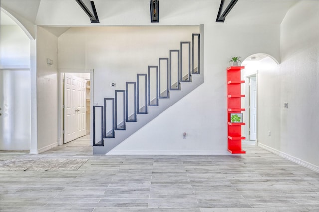 49 Regency Pt, Conroe, TX 77356 - stairs with baseboards, wood finished floors, and arched walkways