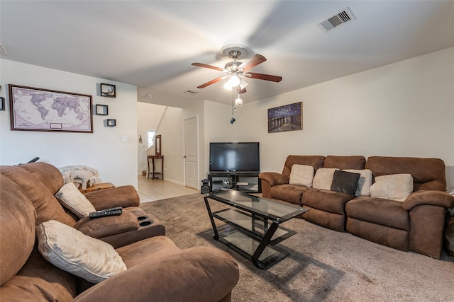 living area with light tile patterned floors, ceiling fan, and visible vents